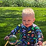 baby, child, pajamas, bubble, grass, outdoor, sunlight, blanket, play, nature, sitting, colorful, fun, daylight, happy, infant, smile, toy, face, person