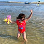 beach_toys, boat, child, fun, happy, outdoor, playful, sand, sea, shore, sky, summer, sunglasses, sunlight, sunny, swimsuit, toddler, vacation, water, water_splash