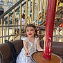 Emma a rejoint le concours — aidez-le/la à gagner de superbes lots ! amusement_ride, building, carousel, child, daylight, floral_dress, footwear, fun, girl, golden_poles, green_shoes, happy, metal, outdoor, playful, portrait, red_pole, seat, smiling, urban