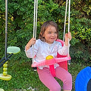 Emma participe au concours pour gagner de l'argent avec cette photo : casual, child, daylight, fun, grass, greenery, happy, nature, outdoor, person, pink_pants, play, playground, rope, shoe, smiling, summer, swing, white_top, young