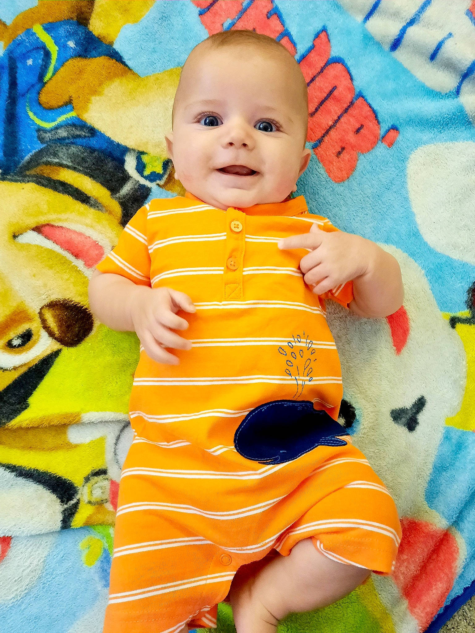 Boden is registered to the contest to win money with this photo: baby, baby_toddler_clothing, cheek, child, clothing, eye, fun, happy, head, orange, pattern, person, pink, skin, sleeve, smile, t_shirt, textile, toddler, white
