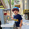 Zain is registered to the contest to win money with this photo: toddler, child, toy_kitchen, water, cap, shirt, outdoor, backyard, play, curious, cup, faucet, clothing, concrete, flowers, staircase, sunlight, person, young_child, casual