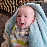 Michael joined the competition — help win amazing prizes! baby, blanket, blue, smiling, infant, striped_clothing, happy, indoor, carpet, soft_texture, cozy, child, person, cute, warm, furniture, pattern, young, toddler, laughing