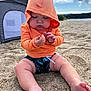 baby, child, hoodie, orange_clothing, beach, sand, tent, lake, water, sky, clouds, nature, outdoor, barefoot, cute, chubby, sitting, summer, playful, casual