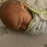Julian is registered to the contest to win money with this photo: baby, newborn, sleeping, blanket, bed, soft_lighting, infant, face, peaceful, resting, swaddled, patterned, fabric, comfort, cute, head, skin, indoors, closeup, person