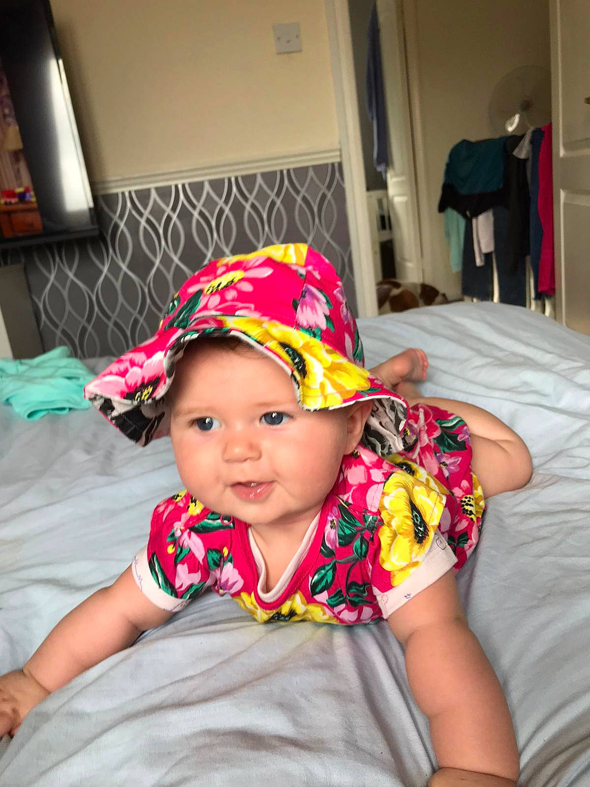 Rae-ann is registered to the contest to win money with this photo: baby, baby_toddler_clothing, cap, chair, child, comfort, fashion_accessory, fun, happy, hat, headwear, leisure, magenta, pattern, person, pink, sitting, sleeve, smile, t_shirt