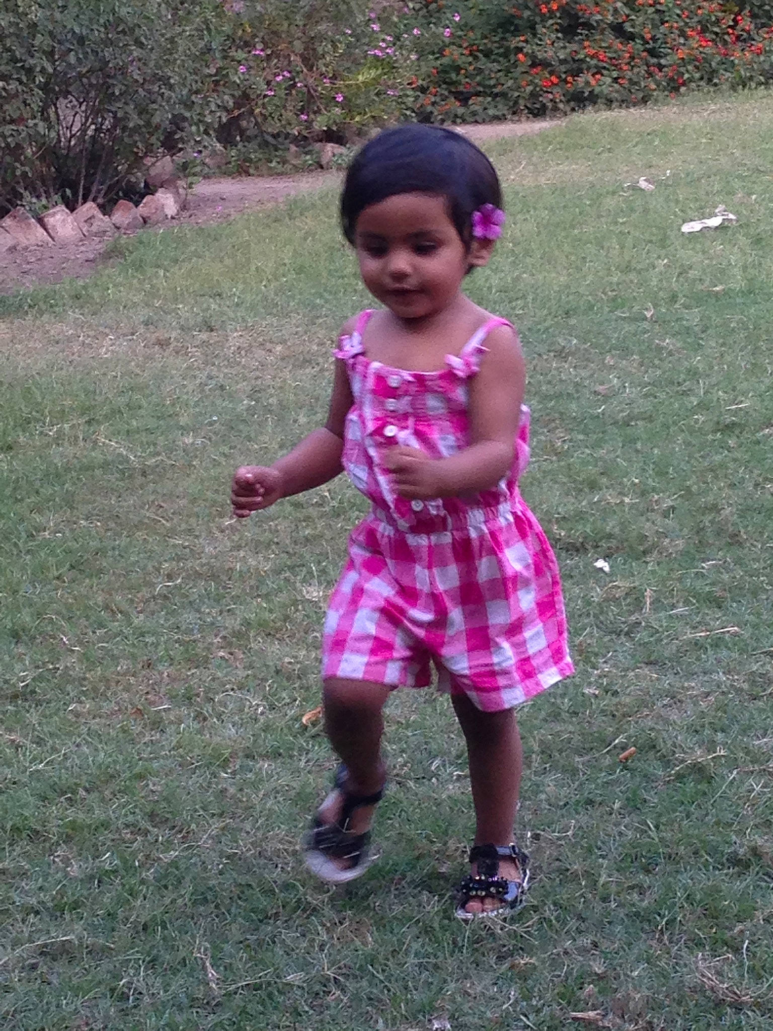 Alisha is registered to the contest to win money with this photo: baby_toddler_clothing, botany, child, design, fun, grass, happy, leisure, magenta, mammal, pattern, people_in_nature, person, pink, plant, purple, recreation, sleeve, smile, toddler