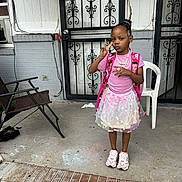 Zari'Yannah Jones joined the competition — help win amazing prizes! child, girl, peace_sign, pink_clothing, tutu_skirt, backpack, jewelry, porch, door, iron_gate, concrete, chalk_drawing, chair, sneakers, expression, outdoor, steps, brick, window, casual