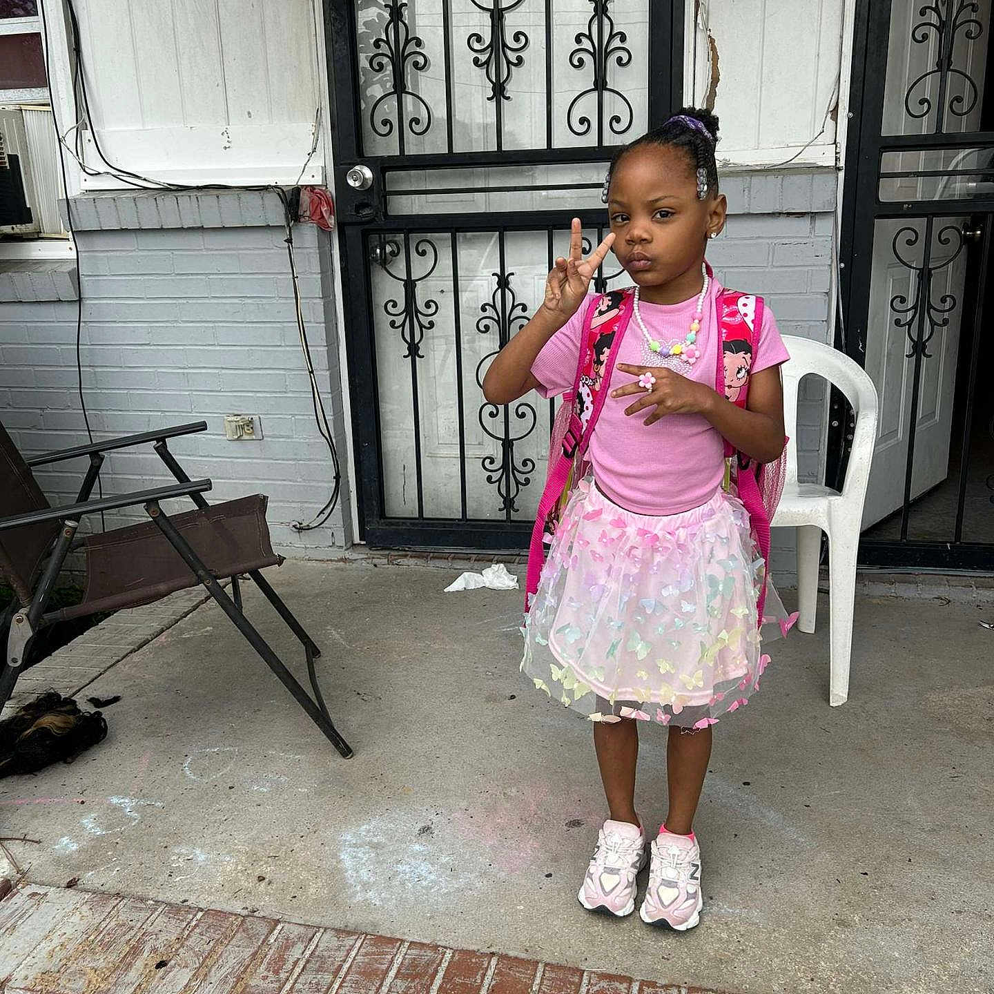 Zari'Yannah Jones joined the competition — help win amazing prizes! backpack, brick, casual, chair, chalk_drawing, child, concrete, door, expression, girl, iron_gate, jewelry, outdoor, peace_sign, pink_clothing, porch, sneakers, steps, tutu_skirt, window