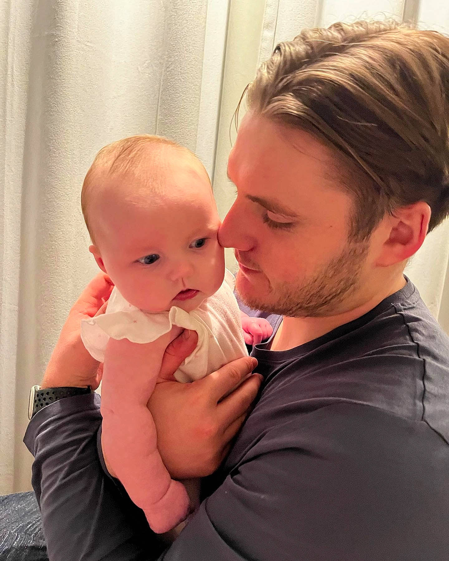 Margot is registered to the contest to win money with this photo: abdomen, baby, baby_toddler_clothing, blond, cheek, comfort, curtain, ear, eye, eyelash, gesture, hand, happy, iris, lip, person, shoulder, stomach, thumb, toddler