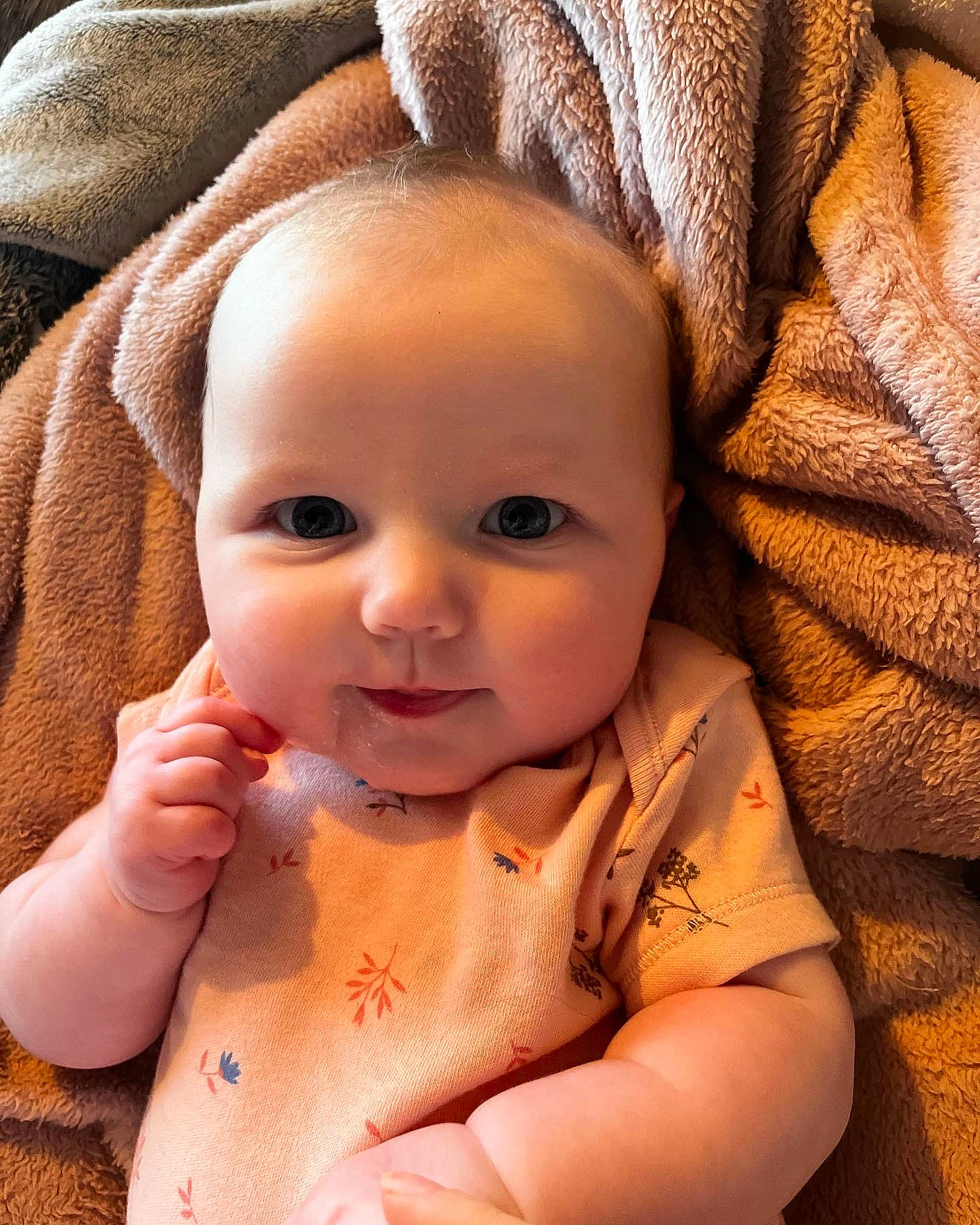 Margot is registered to the contest to win money with this photo: arm, baby, baby_toddler_clothing, cheek, chin, comfort, eye, eyebrow, face, finger, gesture, head, human_body, iris, lip, mouth, neck, nose, person, skin