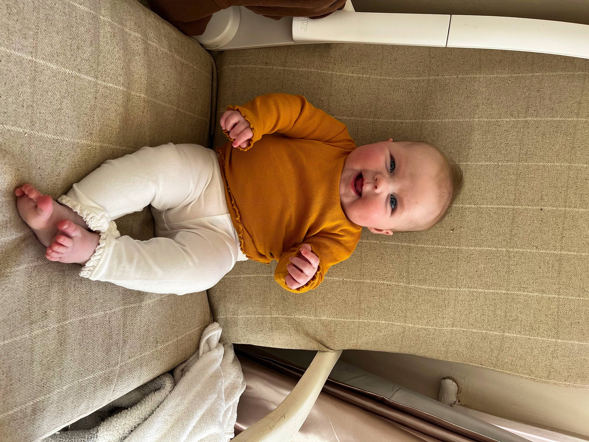 Margot is registered to the contest to win money with this photo: baby, baby_products, baby_safety, baby_sleeping, baby_toddler_clothing, child, comfort, couch, floor, flooring, infant_bed, leg, linens, mammal, people, person, room, sitting, toddler, vertebrate