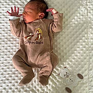 Liam a rejoint le concours — aidez-le/la à gagner de superbes lots ! newborn, baby, infant, sleeping, onesie, chip_and_dale, footed_pajamas, blanket, textured_blanket, applique_teddy_bear, bandage_on_hand, dark_hair, peaceful, portrait, lying_down, small_hands, cozy, soft_lighting, nursery, close_up