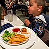 Elijah is registered to the contest to win money with this photo: child, boy, restaurant, food, plate, broccoli, fries, salmon, ketchup, table, drink, glass, straw, people, seated, clothing, cute, waiting, dining, indoor