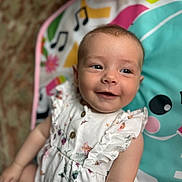 Bobbie joined the competition — help win amazing prizes! baby, smiling, child, infant, play_mat, colorful, cute, portrait, young_child, happy, clothing, dress, patterned, sitting, indoors, face, skin, head, eyes, expression