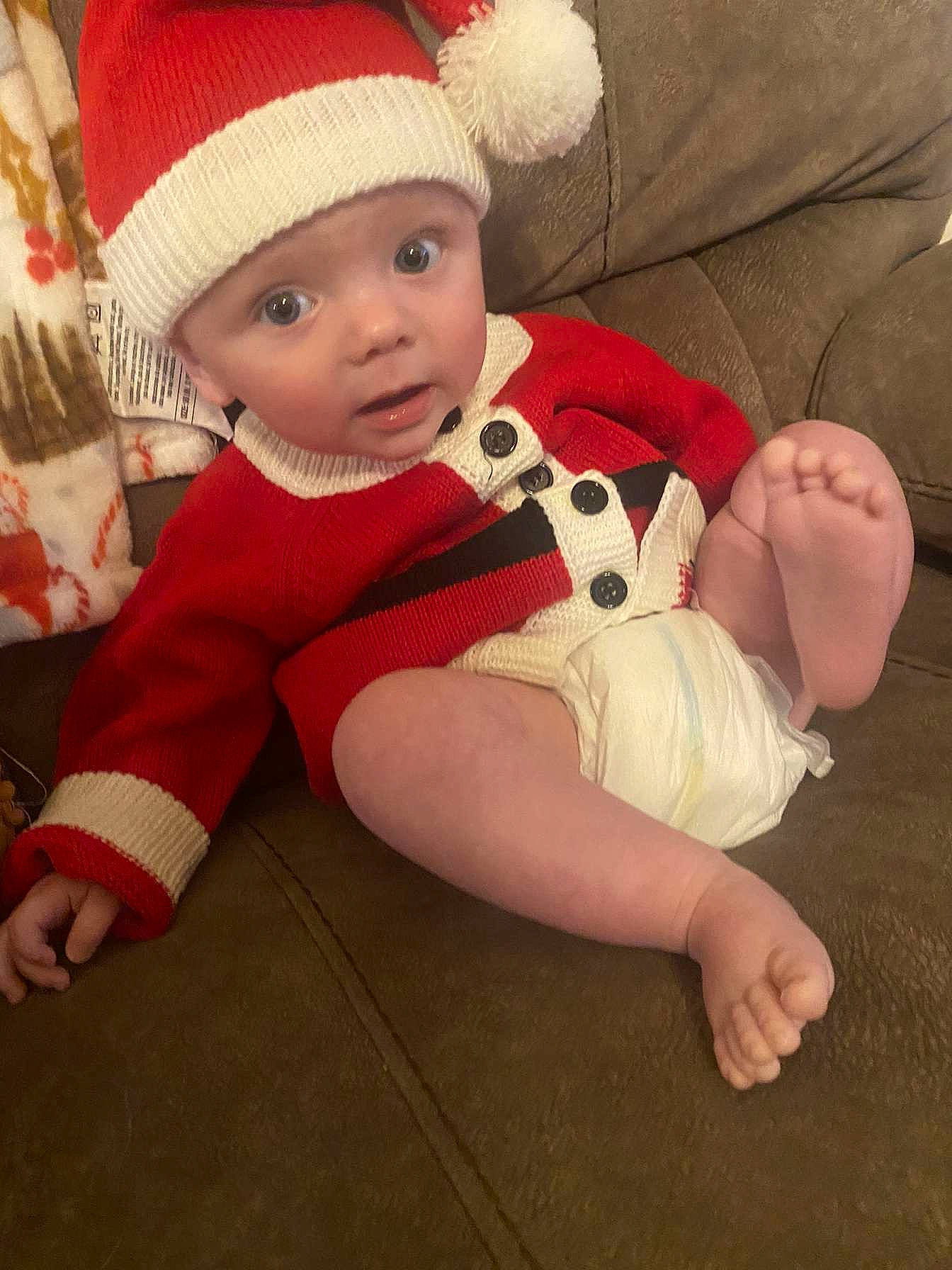 Nathaniel joined the competition — help win amazing prizes! baby, baby_toddler_clothing, cap, cheek, child, comfort, eye, face, facial_expression, hand, head, headgear, headwear, human_body, lap, leg, person, skin, sleeve, sock