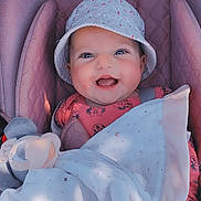 Djena a rejoint le concours — aidez-le/la à gagner de superbes lots ! baby, blanket, bucket_hat, child, clothing, cozy, cute, face, happy, hat, indoors, infant, mickey_mouse, pattern, pink_cushion, plush_toy, portrait, seat, smiling, wrapped