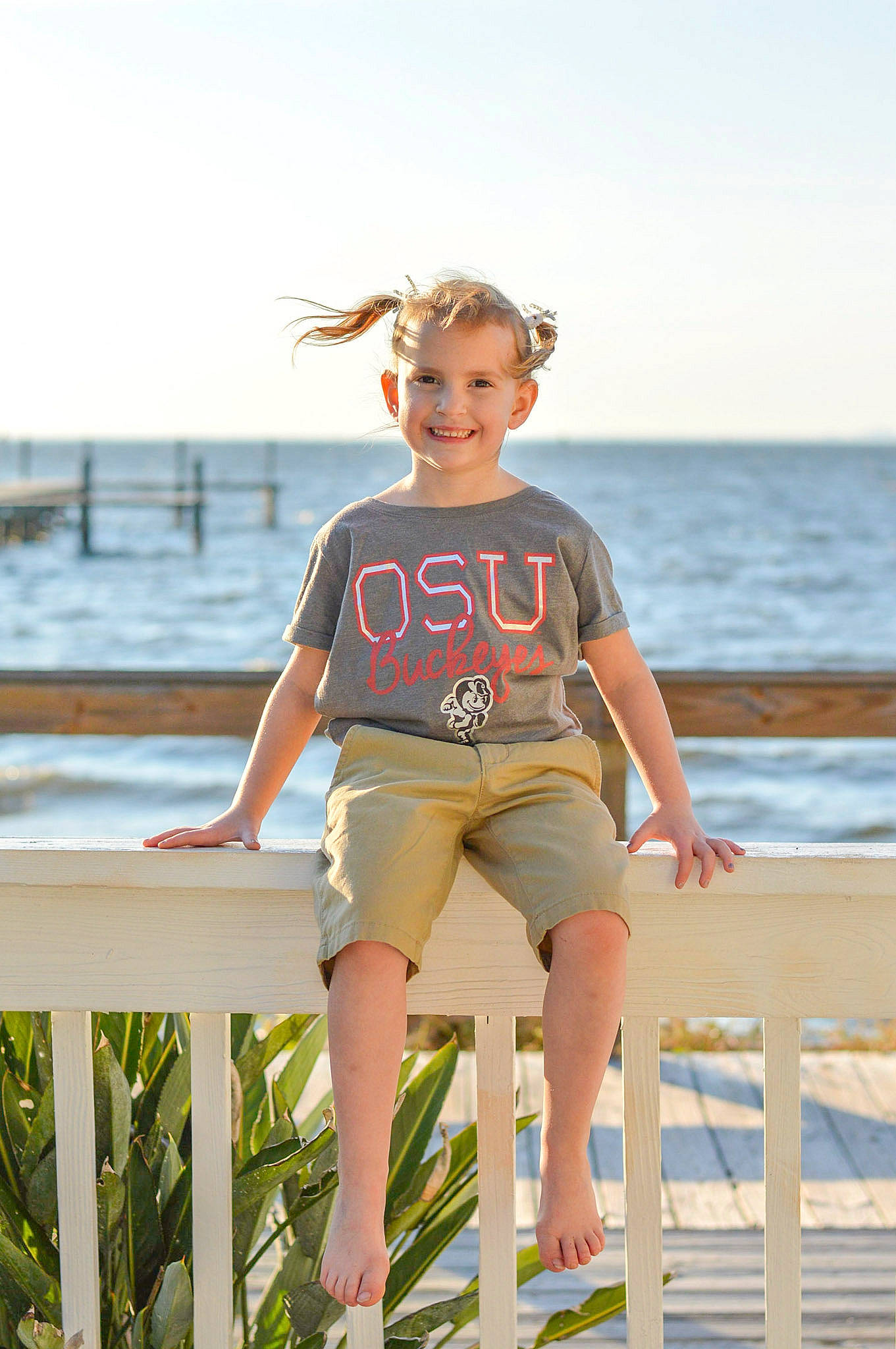 Shailynn is registered to the contest to win money with this photo: beach, child, coast, fun, joy, leg, leisure, ocean, person, sand, sea, shorts, smile, standing, summer, sunlight, t_shirt, vacation, water
