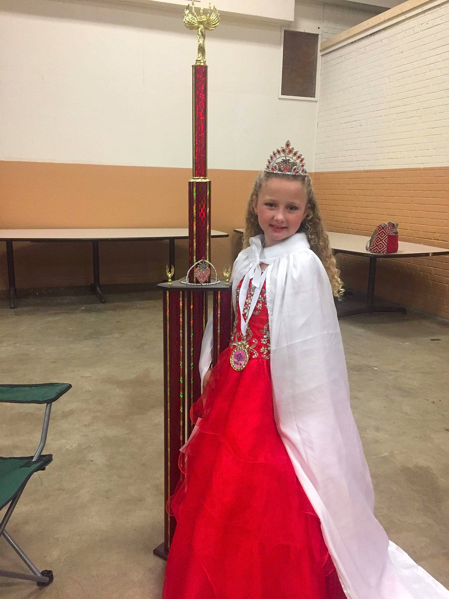 Rayne joined the competition — help win amazing prizes! chair, costume, costume_design, crown, event, fashion_design, fictional_character, flag, flooring, formal_wear, fun, gown, haute_couture, jewellery, joy, magenta, person, room, smile, toddler