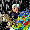 Brookelyn is registered to the contest to win money with this photo: baby, child, infant, headband, bow, sitting, portrait, face, smiling, finger, plush_toy, stuffed_animal, blanket, colorful, couch, indoor, textured_background, clothing, pattern, cozy