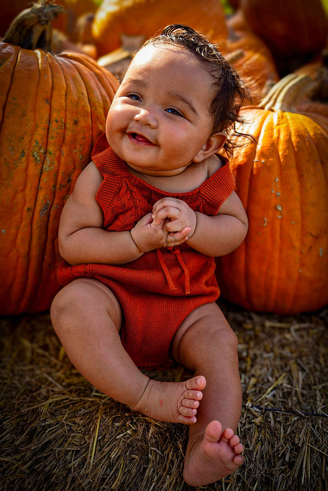 Malahney is registered to the contest to win money with this photo: baby, child, pumpkin, orange_clothing, smiling, fall, autumn, straw, outdoor, cute, happy, portrait, sitting, seasonal, festive, nature, holiday, harvest, skin, face