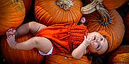 Malahney joined the competition — help win amazing prizes! baby, infant, pumpkin, orange, fall, autumn, cute, child, romper, knitwear, outdoor, seasonal, harvest, nature, skin, foot, hand, face, lying, curious