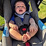 Maylan a rejoint le concours — aidez-le/la à gagner de superbes lots ! baby, car_seat, blue_hat, smiling, sunlight, outdoor, baby_boy, straps, happy, toes, clothing, face, child, infant, seat, cushion, safety_harness, grass, daylight, portrait