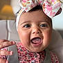 Kinslee Mae is registered to the contest to win money with this photo: baby, infant, child, smiling, open_mouth, headband, bow, floral_pattern, onesie, strap, highchair, hand, eyes, cheeks, close_up, portrait, soft_lighting, bokeh, lamp, adorable
