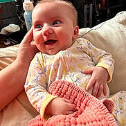 Ellianna is registered to the contest to win money with this photo: baby, smiling, infant, pajamas, blanket, hand, bottle, happy, indoor, person, cute, face, child, cozy, soft, cradled, home, comfort, newborn, relaxed