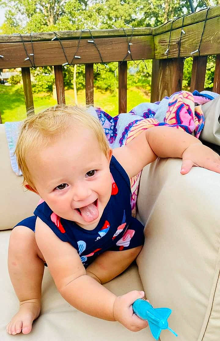 Remington is registered to the contest to win money with this photo: arm, baby, baby_toddler_clothing, blue, fun, happy, human_body, joint, leg, leisure, mammal, muscle, organ, people, person, plant, skin, smile, toddler, tree
