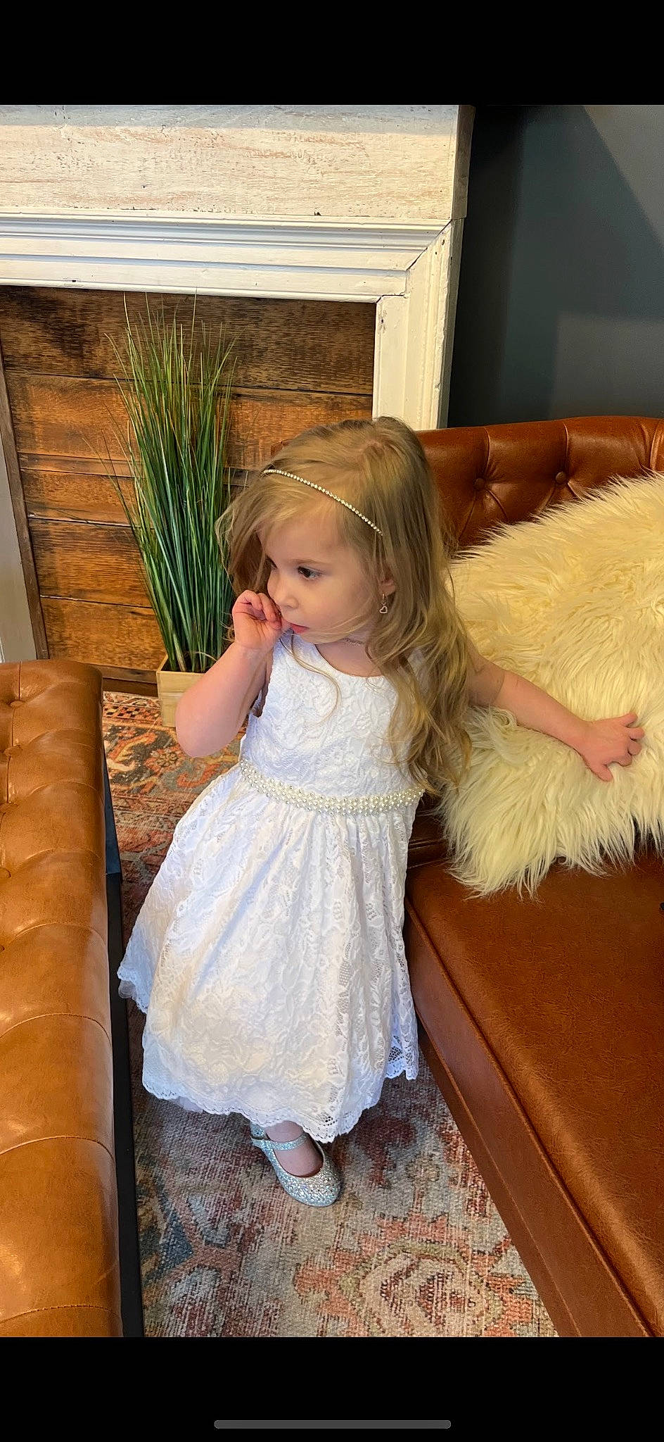 Capri joined the competition — help win amazing prizes! baby_toddler_clothing, blond, child, couch, dress, floor, flooring, fun, grass, happy, human_leg, living_room, long_hair, person, plant, room, sitting, sock, television, toddler