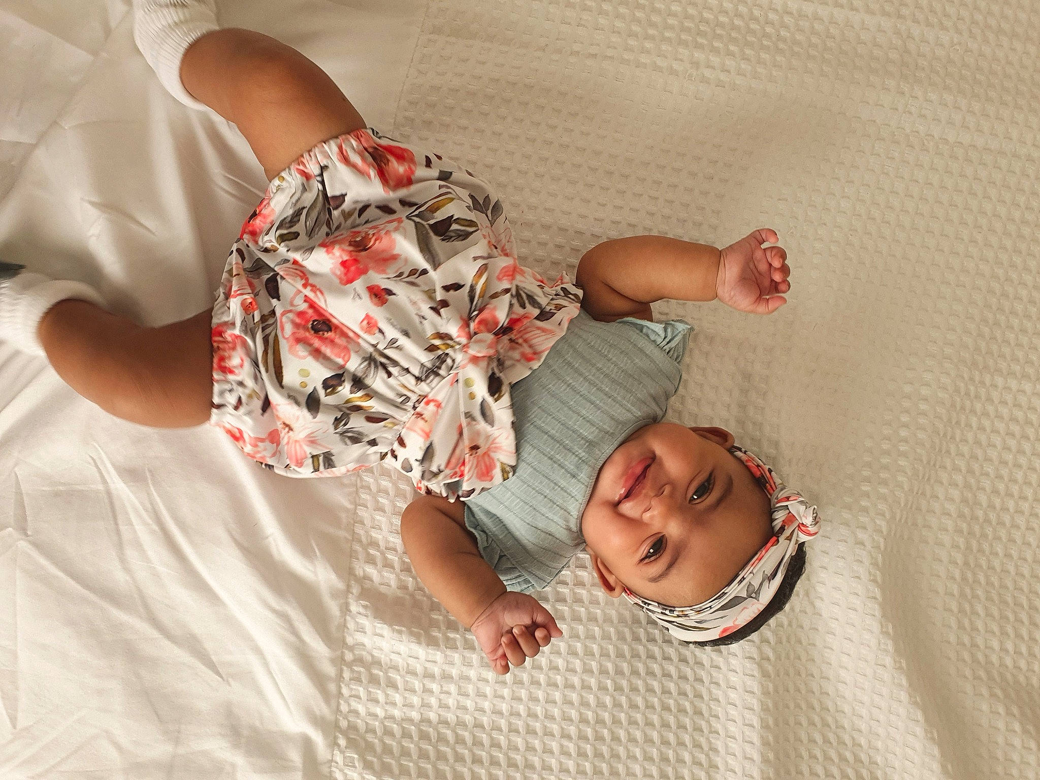 Haniyah joined the competition — help win amazing prizes! baby_sleeping, baby_toddler_clothing, bed, bedding, child, comfort, finger, fun, gesture, happy, headwear, human_body, joint, linens, mouth, pattern, person, skin, sleeve, smile