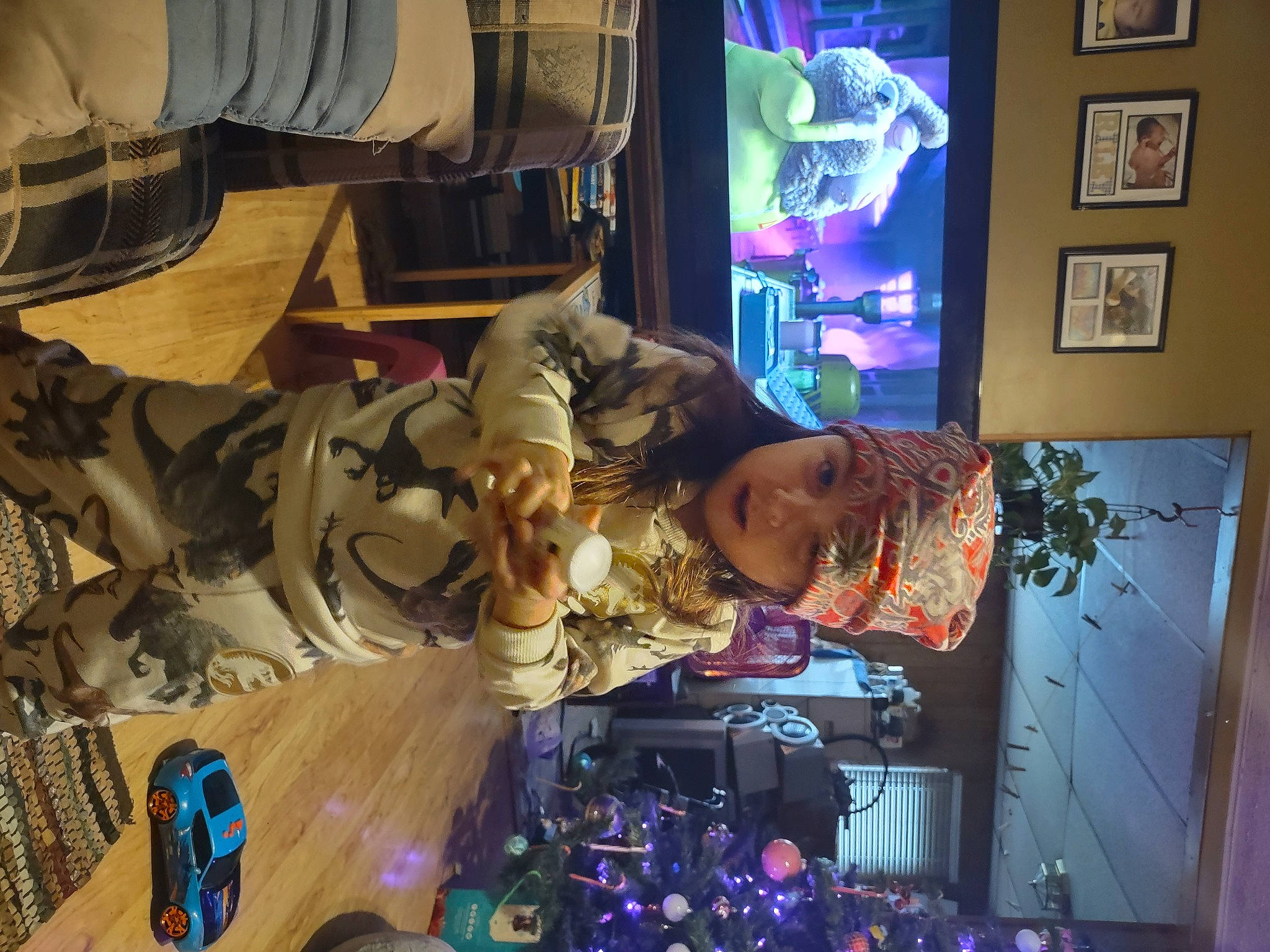 Riley joined the competition — help win amazing prizes! collection, display_device, electronics, event, fun, games, hat, headwear, machine, person, personal_protective_equipment, plant, purple, retail, room, shelf, shoe, space, technology, television_set