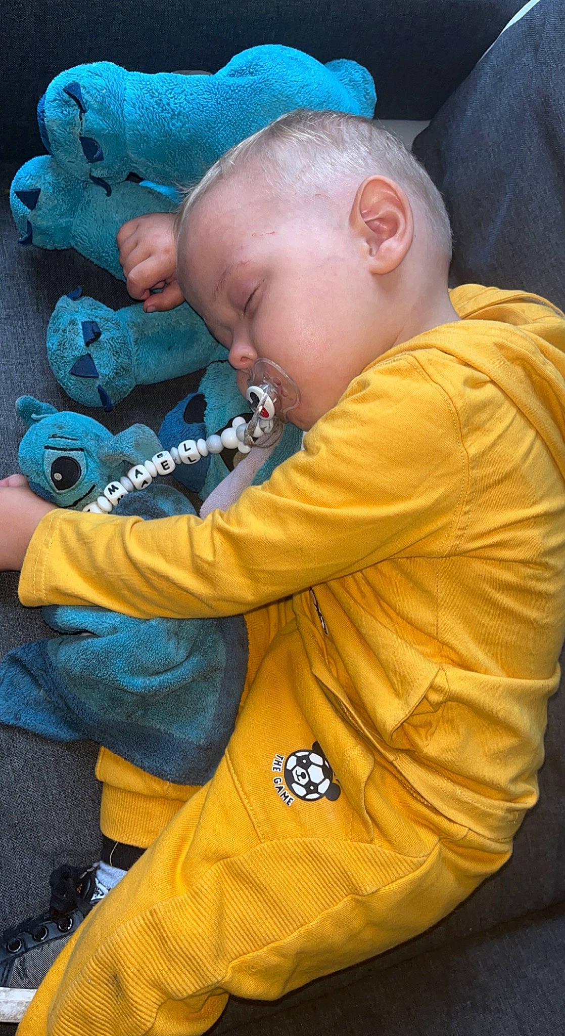 Timaël participe au concours pour gagner de l'argent avec cette photo : baby, baby_products, baby_toddler_clothing, baby_toys, blue, child, electric_blue, finger, fun, nose, pattern, person, personal_protective_equipment, play, sitting, skin, sleeve, stuffed_toy, toddler, toy