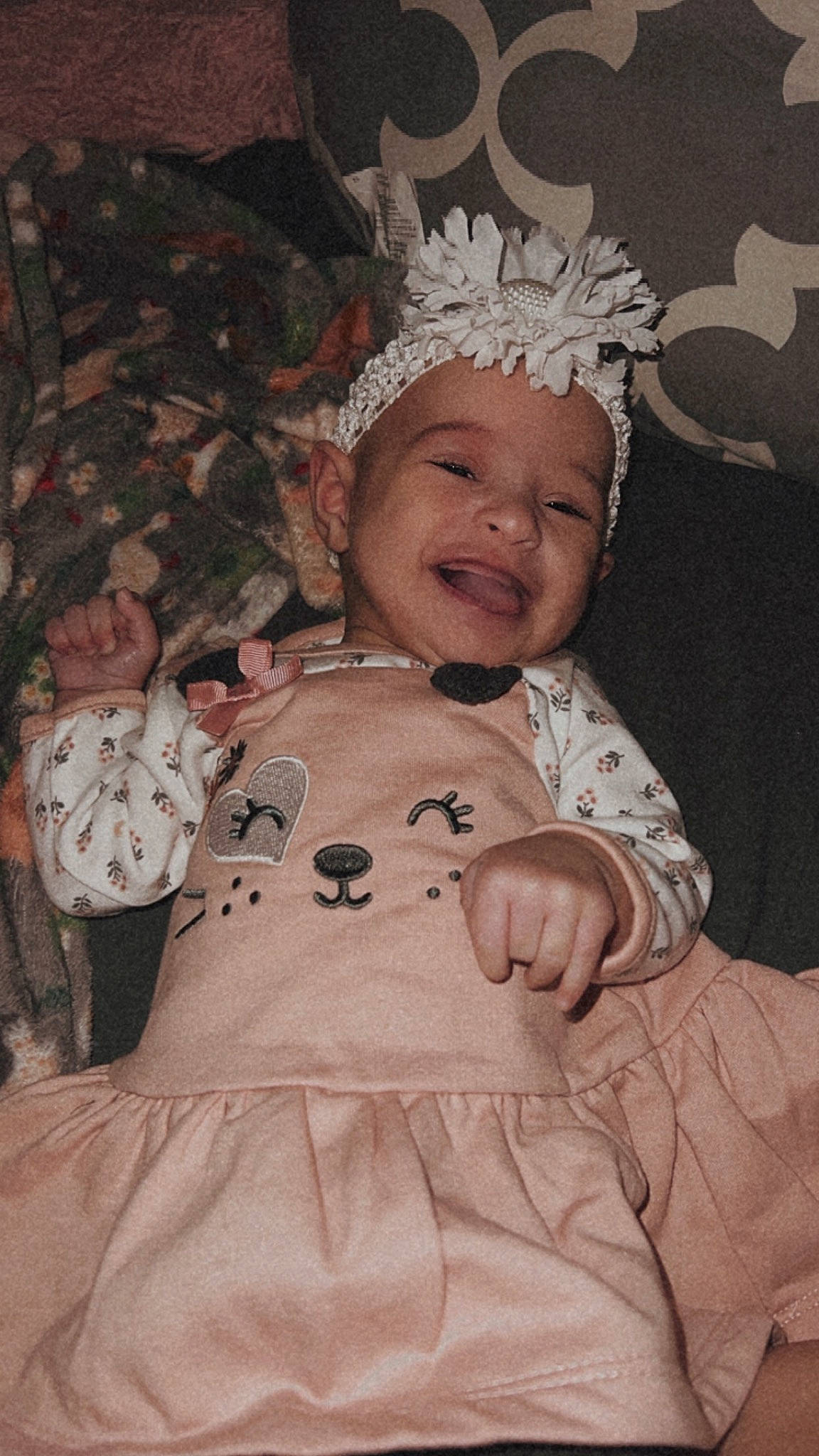 Leilani is registered to the contest to win money with this photo: baby, baby_toddler_clothing, child, costume_hat, crown, event, face, fun, fur, happy, headpiece, headwear, holiday, peach, person, pink, room, sleeve, smile, toddler