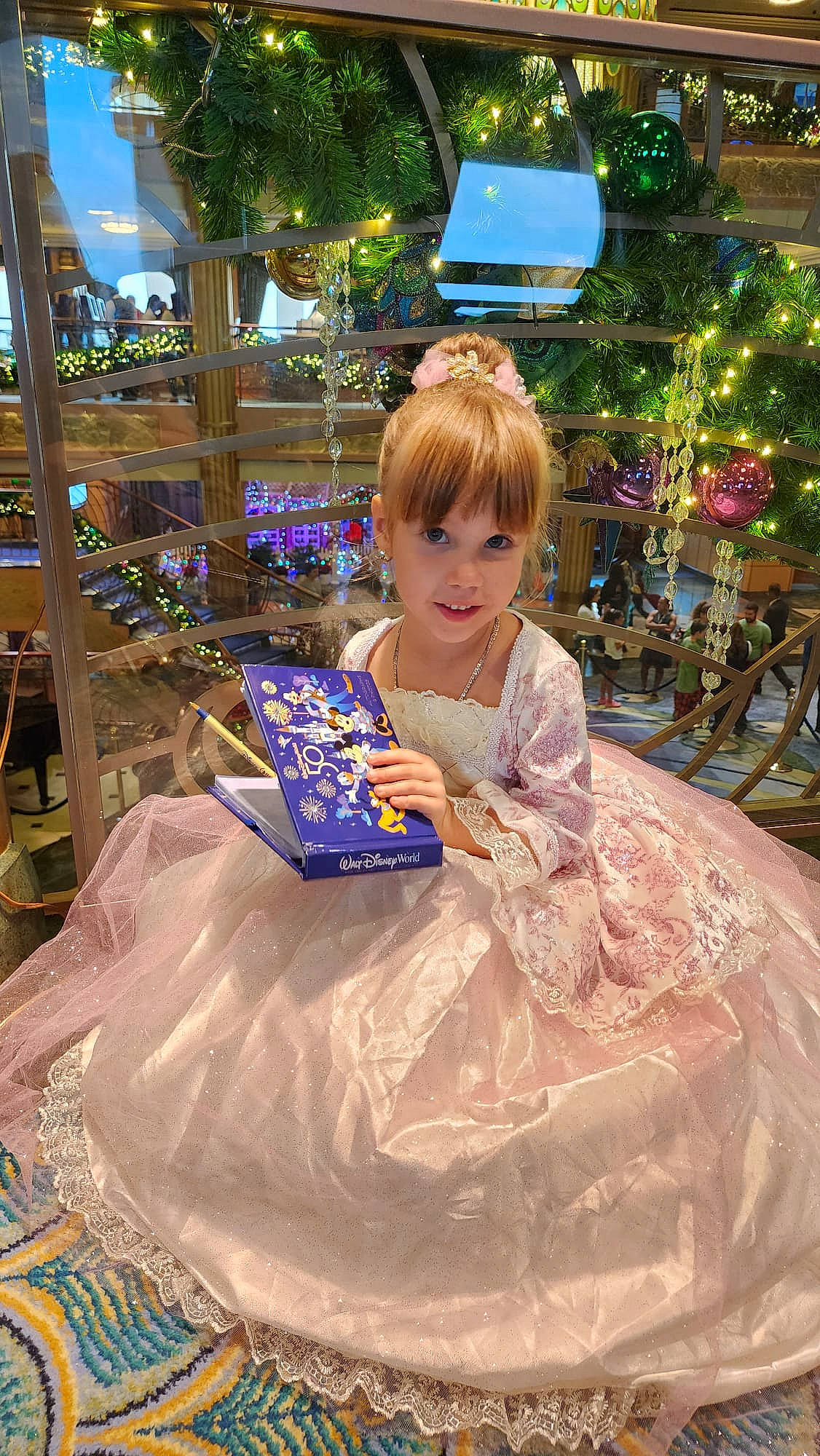 Carolina is registered to the contest to win money with this photo: beauty, bridal_accessory, child, dress, embellishment, event, formal_wear, fun, gown, grass, hairstyle, happy, leisure, person, pink, plant, sitting, smile, toddler, toy