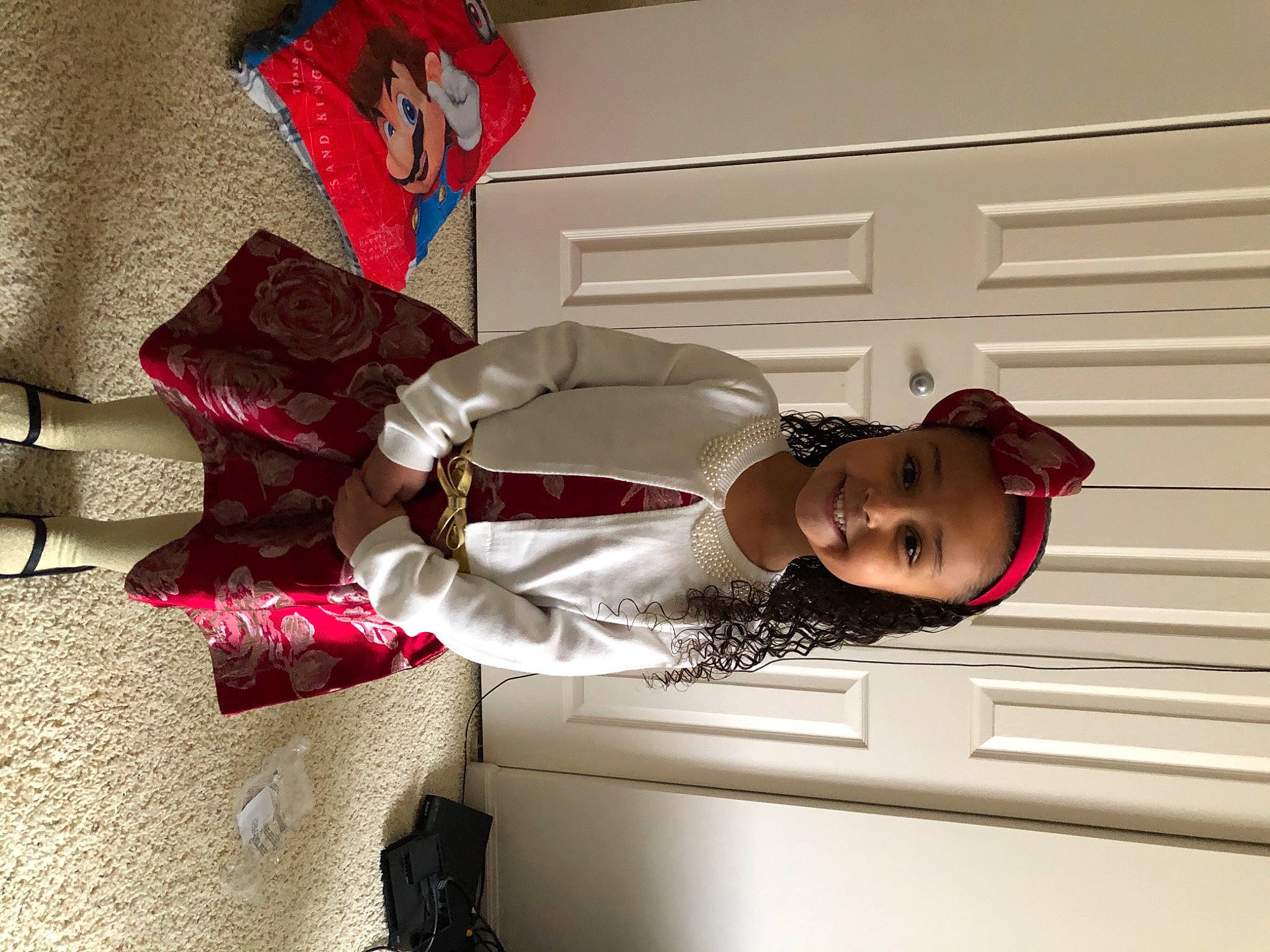 Emily is registered to the contest to win money with this photo: carmine, child, comfort, costume, dress, eyewear, fashion_accessory, fashion_design, fun, happy, hat, human_leg, joy, magenta, pattern, person, room, sitting, smile, street_fashion