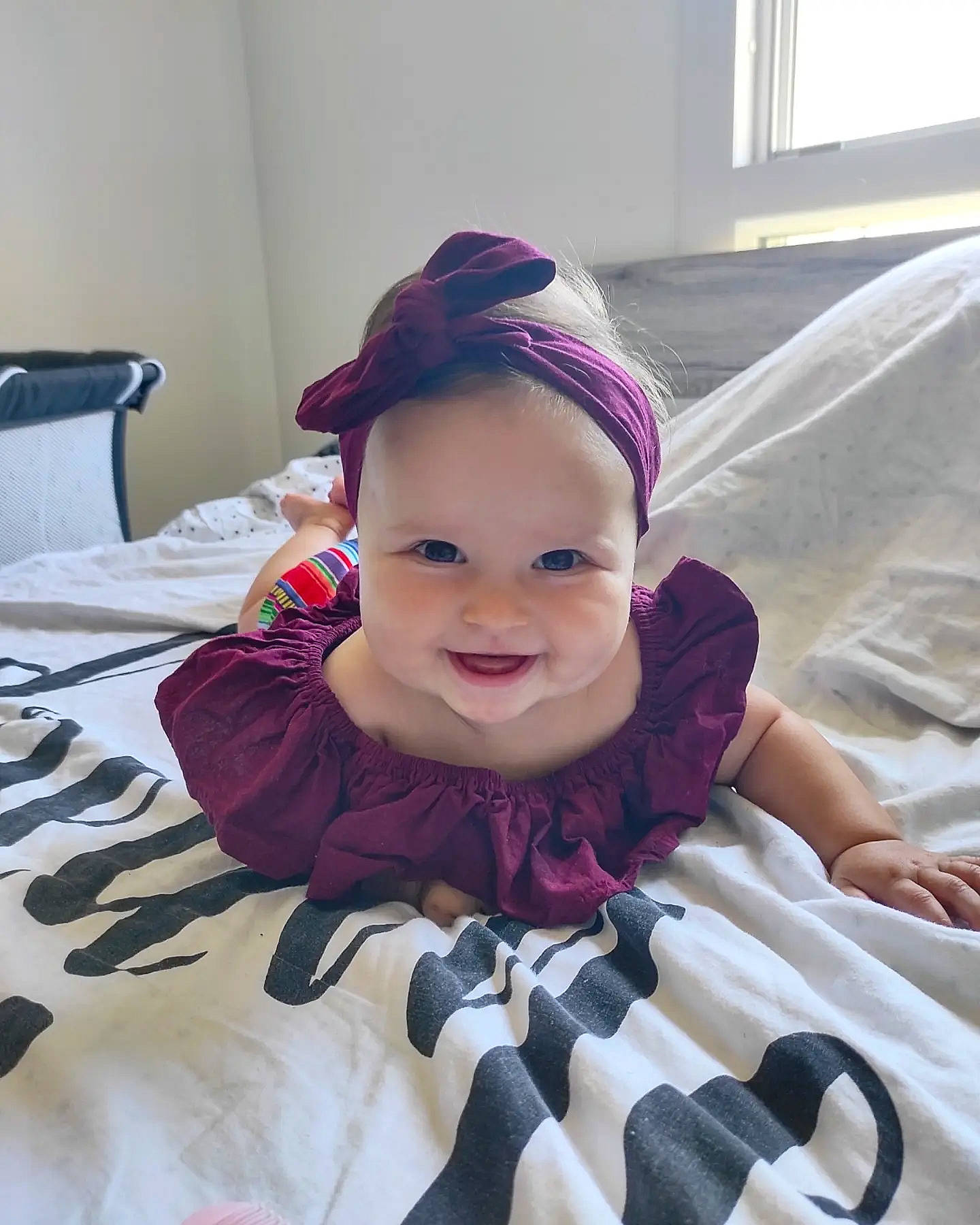 Gioia participe au concours pour gagner de l'argent avec cette photo : baby, baby_toddler_clothing, cap, child, comfort, eye, fun, happy, head, headwear, joy, linens, magenta, mouth, outerwear, pattern, person, pink, purple, skin