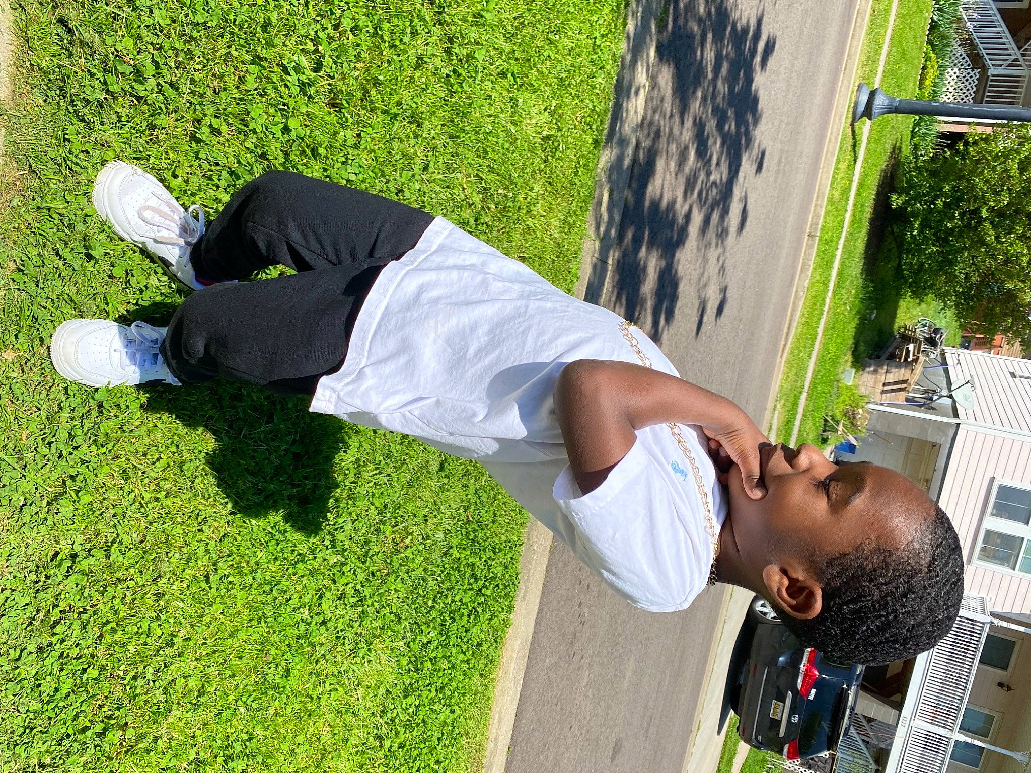 Trasean is registered to the contest to win money with this photo: artificial_turf, child, daytime, elbow, footwear, fun, grass, happy, human_leg, joint, knee, leisure, people_in_nature, person, plant, recreation, shoe, sneakers, t_shirt, tree