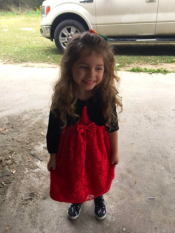 Sophee is registered to the contest to win money with this photo: car, child, joy, long_hair, outerwear, person, red, smile, standing, toddler