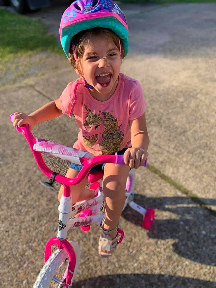 Sophee is registered to the contest to win money with this photo: bicycle, bicycle_accessory, bicycle_pedal, bicycle_wheel, bicycles_equipment_and_supplies, bmx_bike, child, cycling, fun, headwear, helmet, person, pink, play, recreation, road_bicycle, smile, sports_equipment, toddler, training_wheels