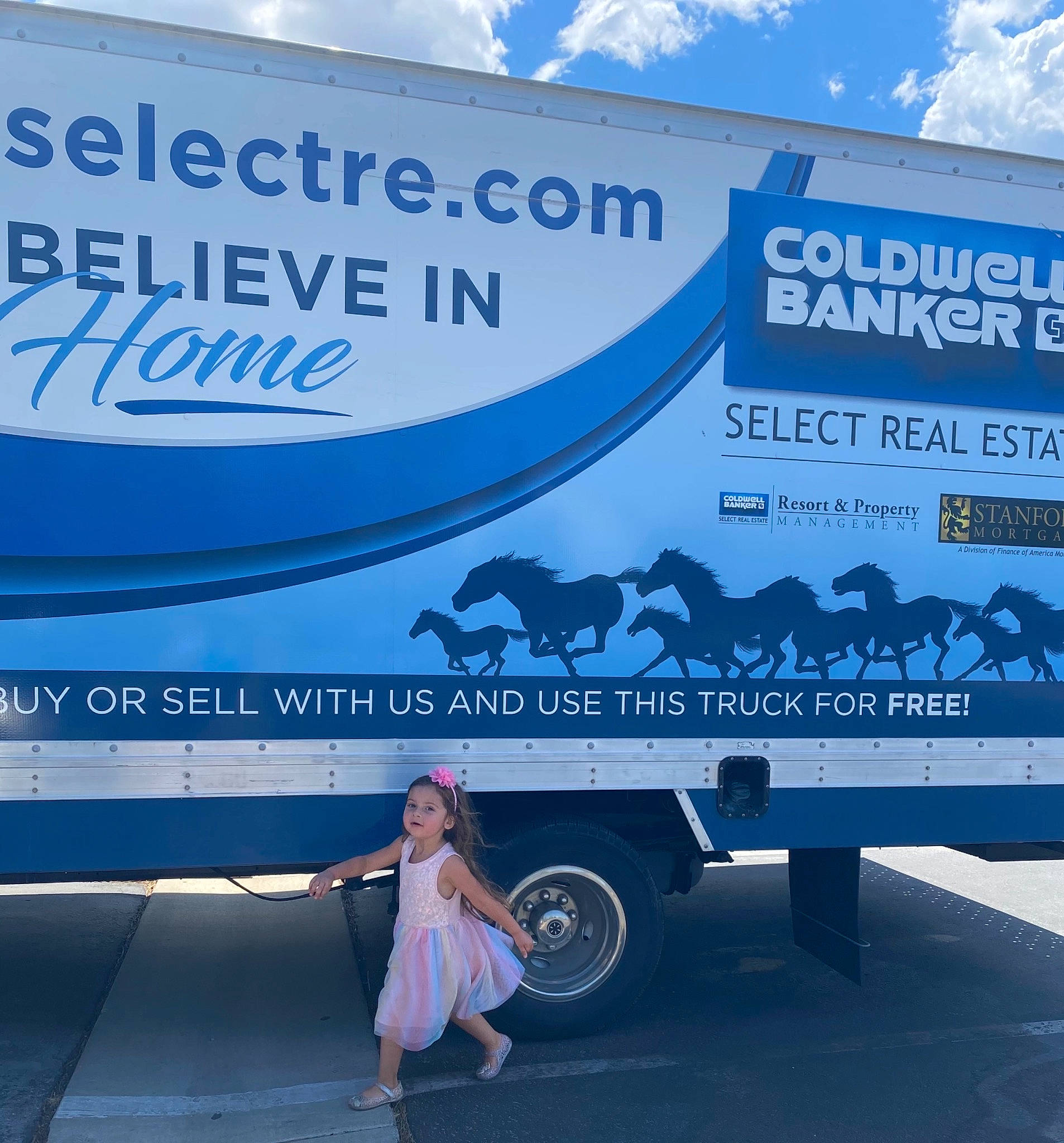 Alysia is registered to the contest to win money with this photo: advertising, air_travel, automotive_design, automotive_exterior, automotive_tire, automotive_wheel_system, billboard, blue, cloud, electric_blue, font, mode_of_transport, motor_vehicle, person, signage, sky, tire, travel, truck, vehicle