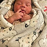 Xiomara joined the competition — help win amazing prizes! baby, newborn, sleeping, blanket, sheep_pattern, cute, infant, wrapped, soft, peaceful, hand, finger, face, cozy, child, portrait, indoors, warm, comfort, rest