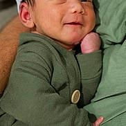 Aemond is registered to the contest to win money with this photo: baby, button, child, closeup, cozy, cute, cute_expression, fabric, green_clothing, hand, hat, infant, newborn, person, portrait, resting, skin, sleepy, smile, soft_texture