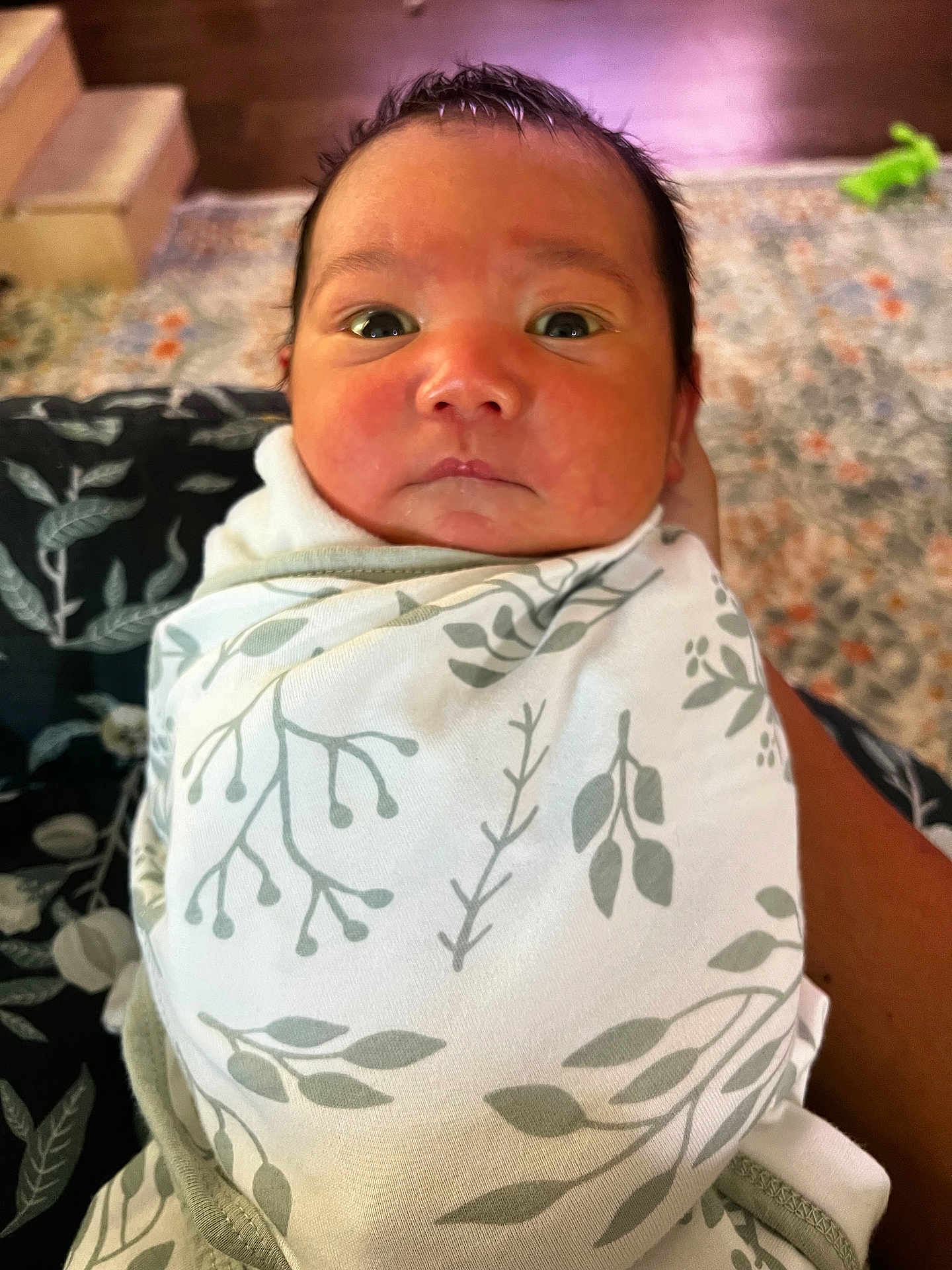 Aemond is registered to the contest to win money with this photo: baby, infant, swaddled, blanket, pattern, face, eyes, expression, indoor, carpet, floor, person, hand, skin, head, newborn, cute, child, portrait, clothing