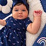 adorable, baby, blanket, blue_eyes, bow, child, close_up, cozy, headband, indoor, infant, lying_down, navy_dress, plush, portrait, rainbow_pattern, safe, smiling, stuffed_animal, teddy_bear