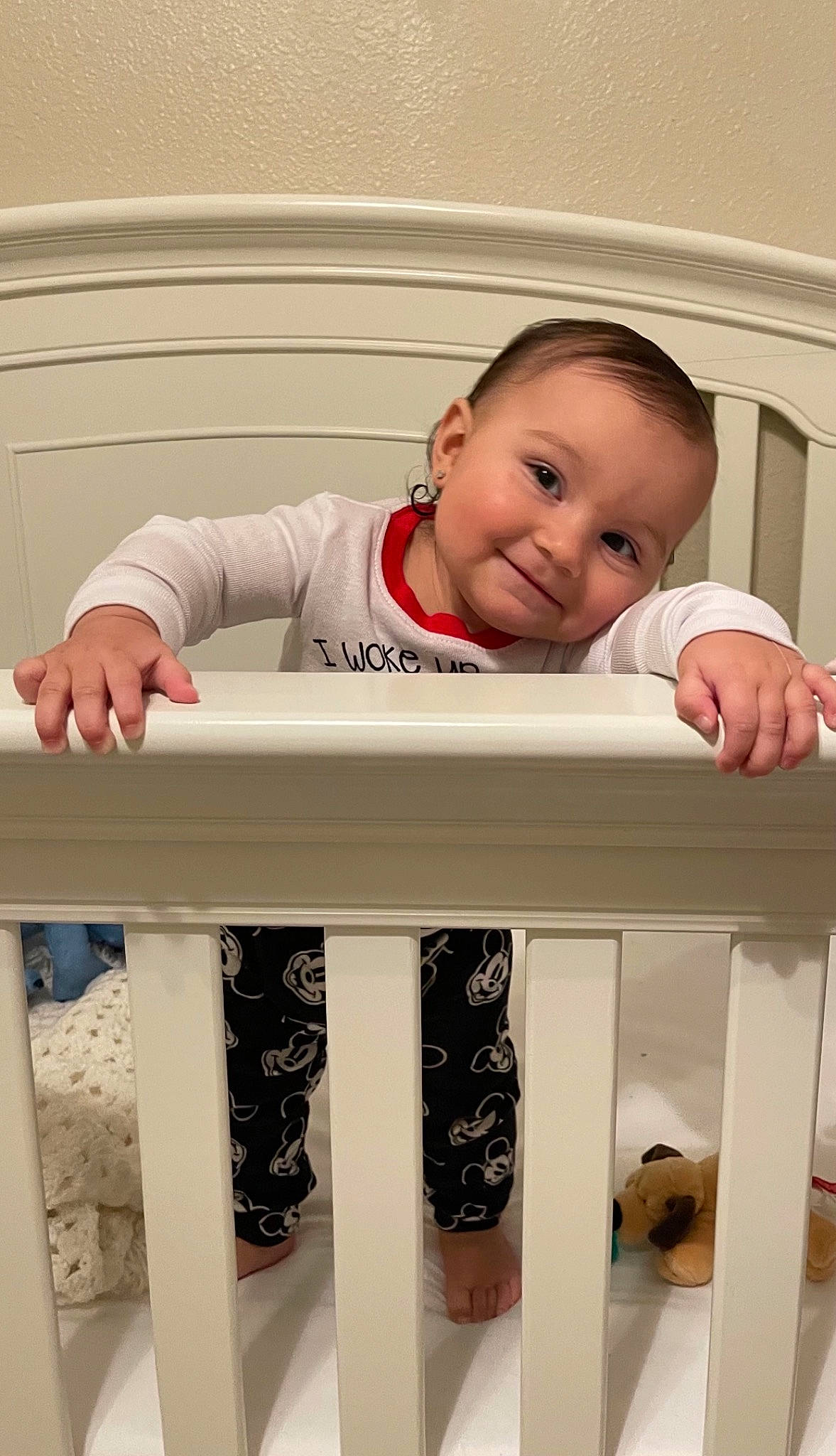 Carter is registered to the contest to win money with this photo: arm, baby, baby_safety, baby_toddler_clothing, cradle, eye, face, facial_expression, floor, head, house, human_body, infant_bed, joy, nursery, outerwear, person, sleeve, smile, standing