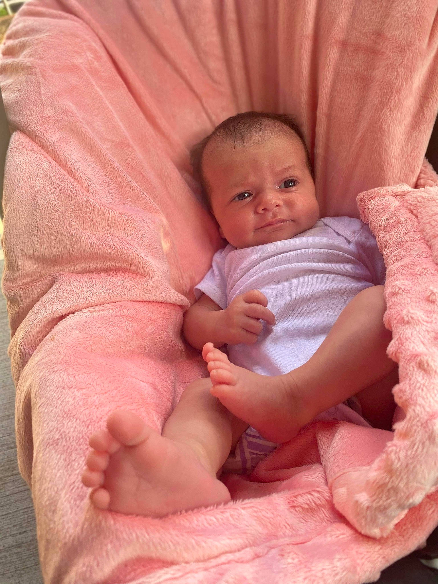 Royalle is registered to the contest to win money with this photo: arm, baby, baby_toddler_clothing, cheek, chin, comfort, facial_expression, finger, gesture, human_body, iris, lap, leg, lip, mouth, person, pink, skin, sleeve, stomach