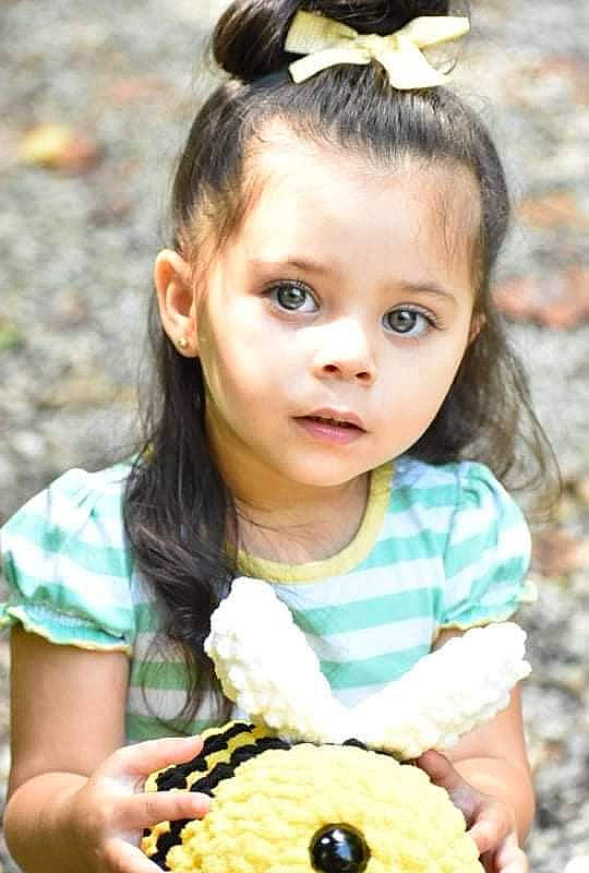 Emilie is registered to the contest to win money with this photo: baby_toddler_clothing, beauty, child, eyelash, facial_expression, finger_food, grass, hairstyle, happy, iris, organ, pattern, people, person, photograph, recipe, skin, snapshot, sweetness, toddler