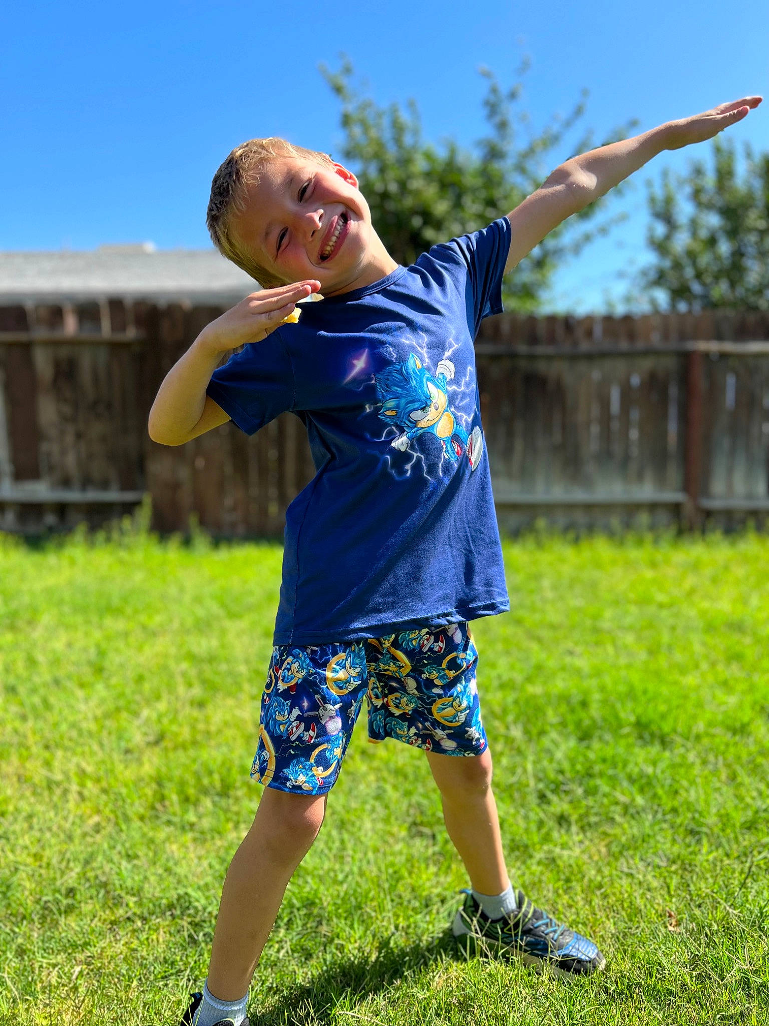 Drayton is registered to the contest to win money with this photo: electric_blue, fun, gesture, grass, grass_family, grassland, happy, joy, leisure, meadow, people_in_nature, person, player, recreation, shorts, sky, smile, summer, t_shirt, toddler